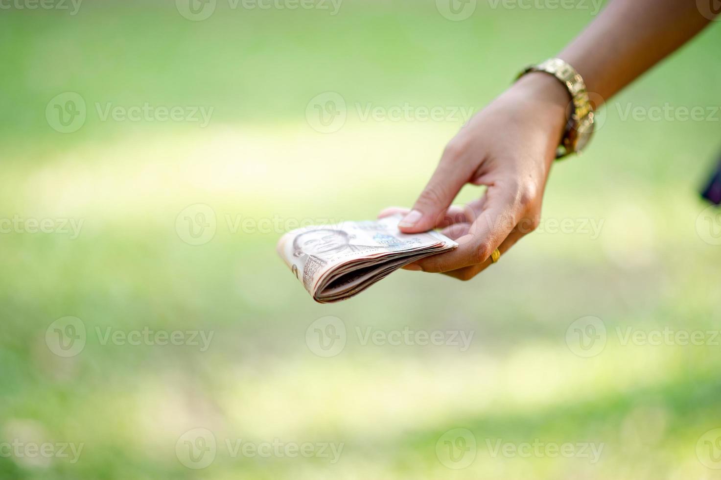 Hand and money, multiple banknotes of financial executives For business and daily spending photo