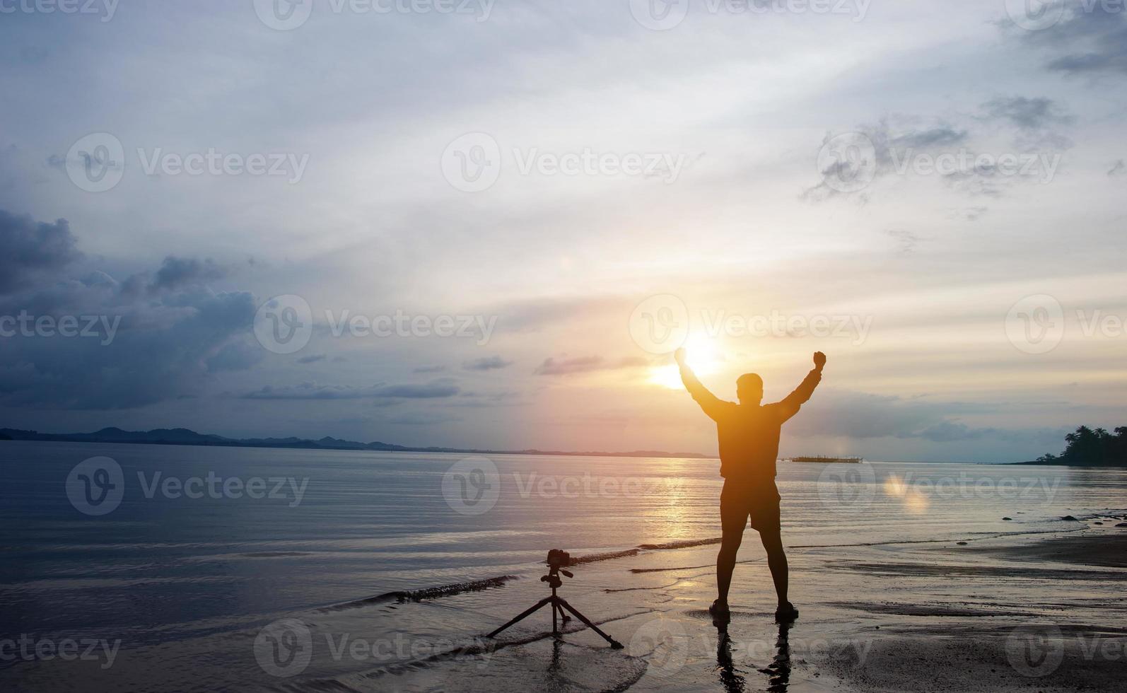 The photographer is happy by the sea and is happy with his photography. photo