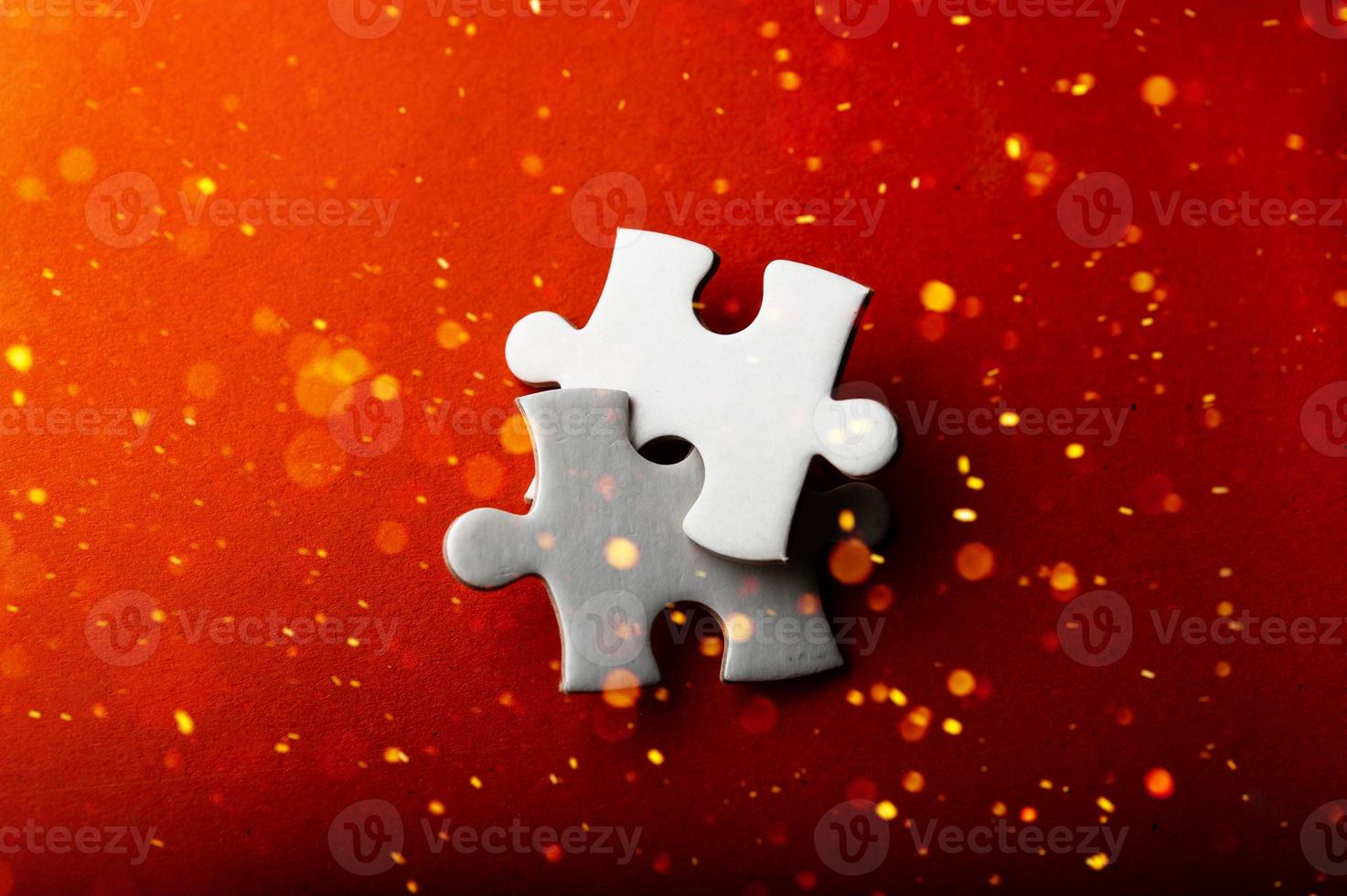 White puzzles placed on an orange background Represent the unity and power of successful people photo