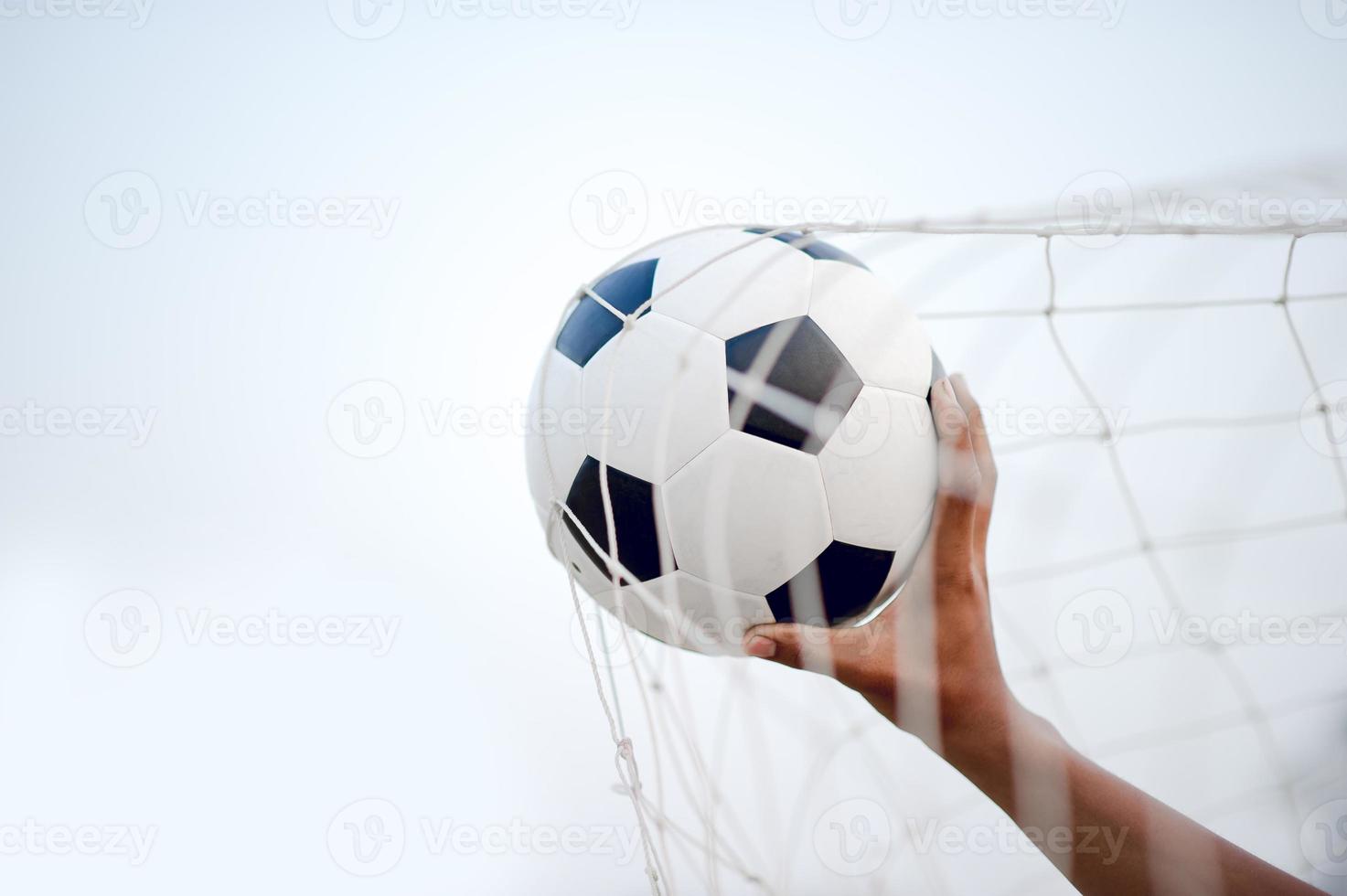 The cropped image of sports players who catch the ball and the football field. Sports-image concept. photo