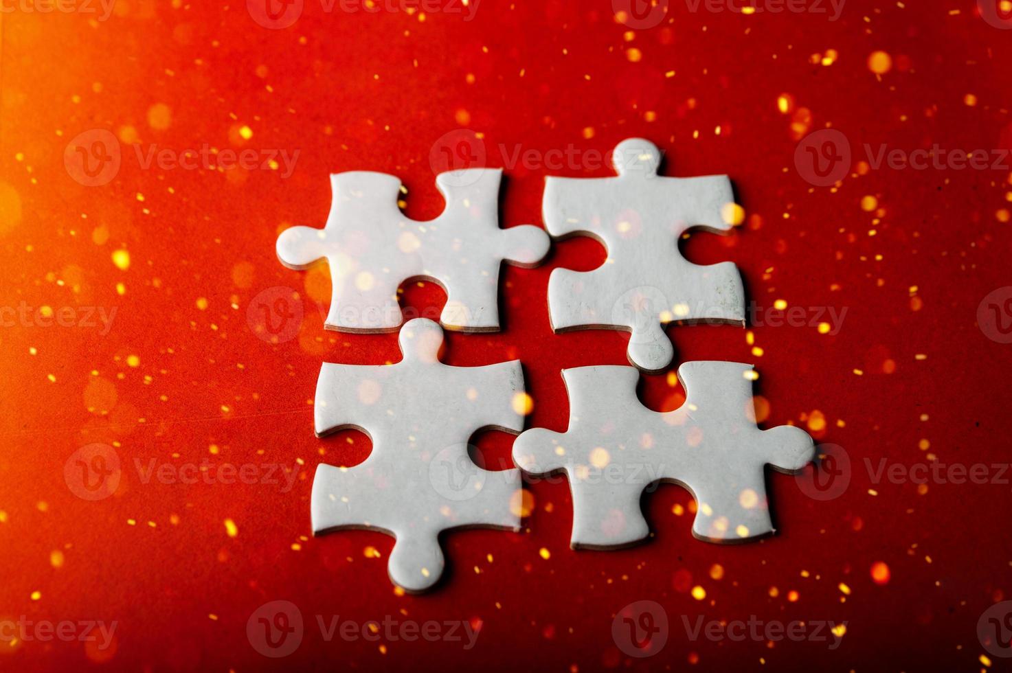 White puzzles placed on an orange background Represent the unity and power of successful people photo