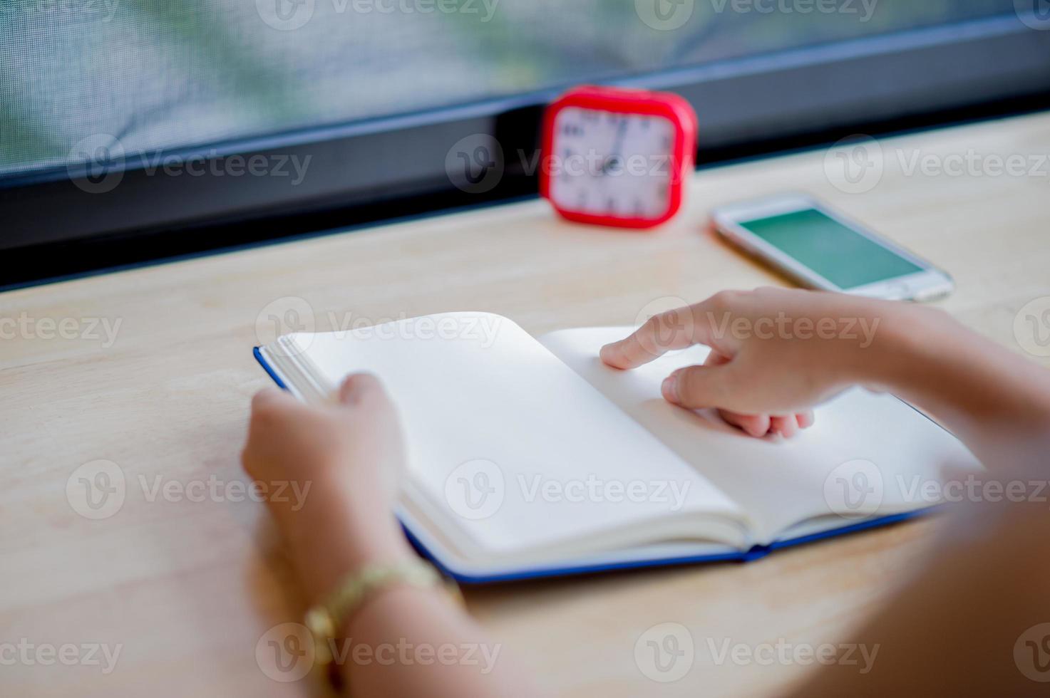 Hands and books that are laid bare with space In the morning room Book reading concept photo