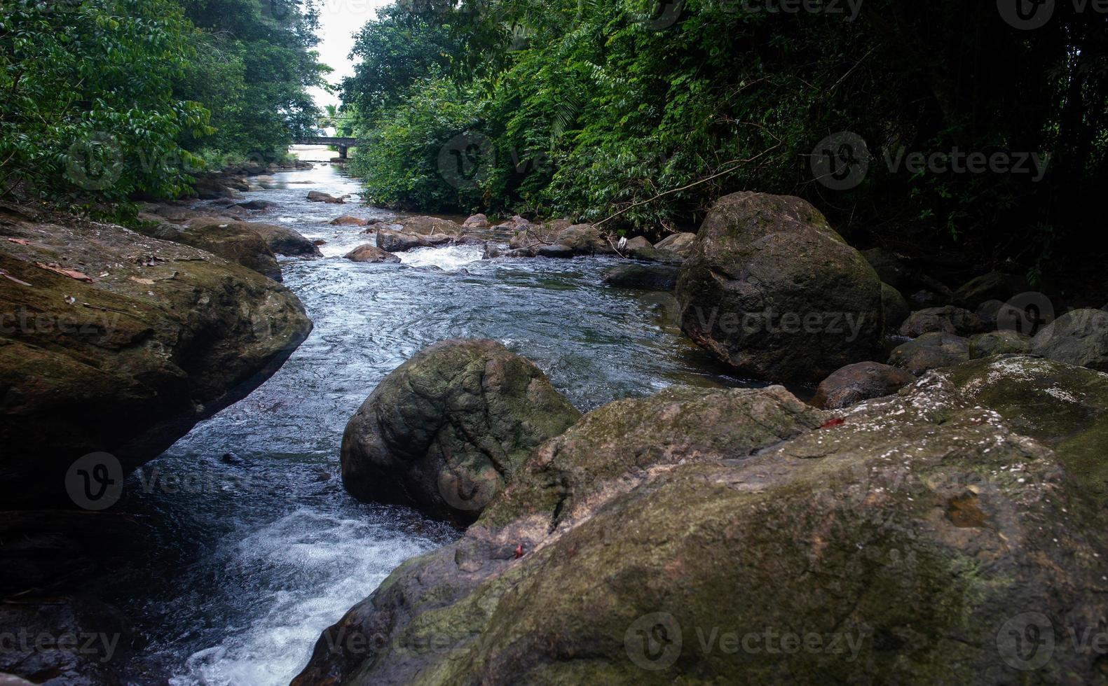 Natural waterfall, shoulder river, through the top of the mountain photo