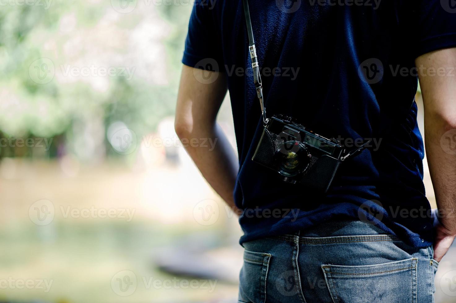 Hand and camera of the photographer Travel in the mountains and nature Concept photographer photo