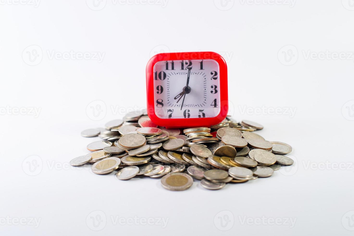 Money, baht coins on a white background and a red clock photo