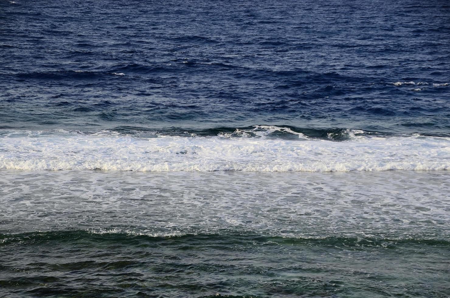 low smooth waves in ocean photo