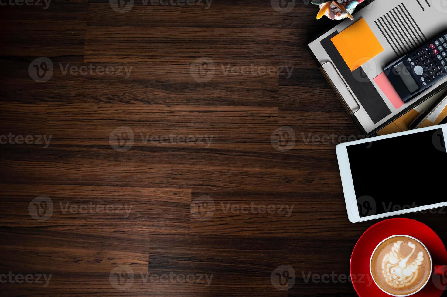 Top view of office desktop with various supplies and devices. Workplace concept photo