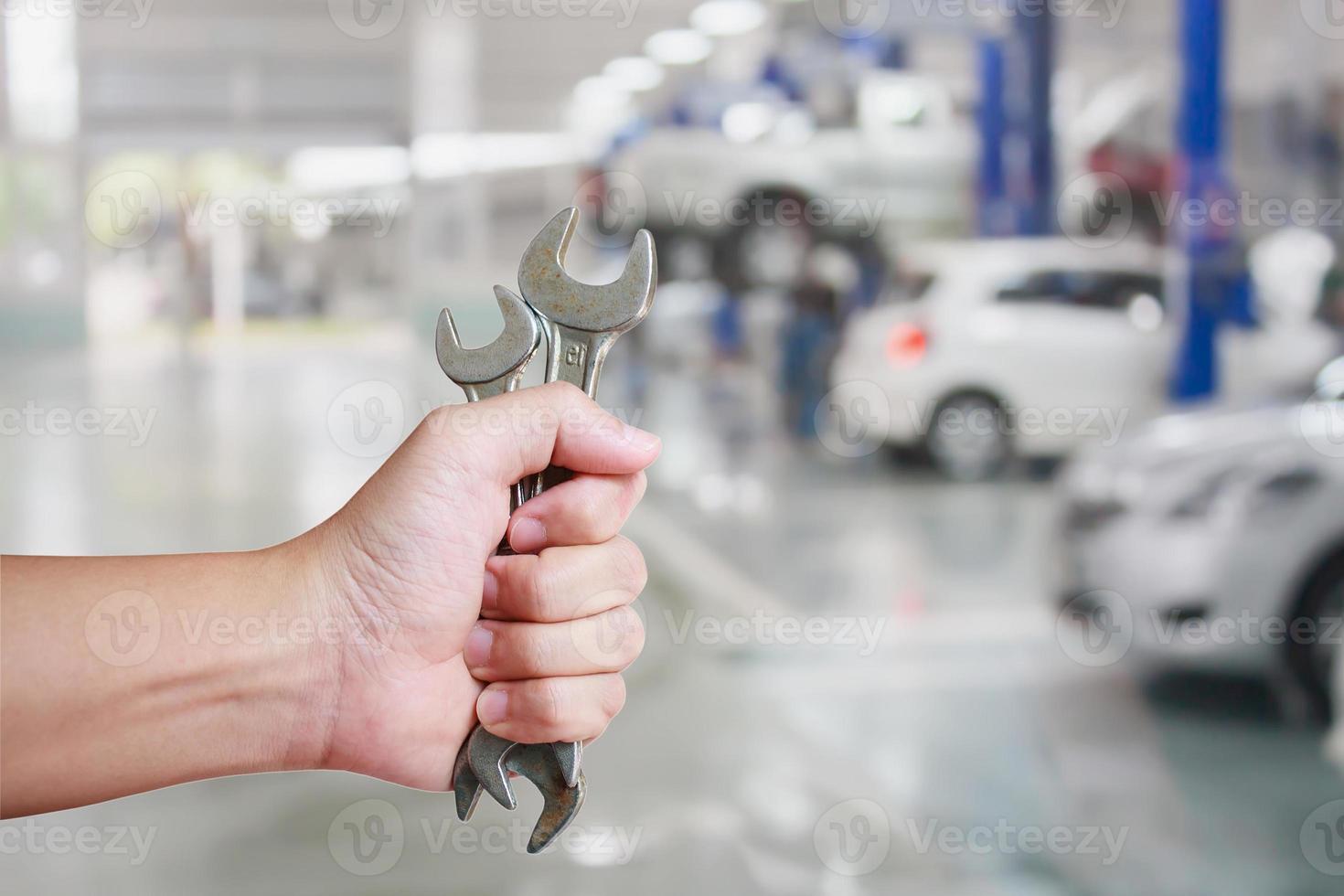 Hand of professional Auto mechanic with wrench photo