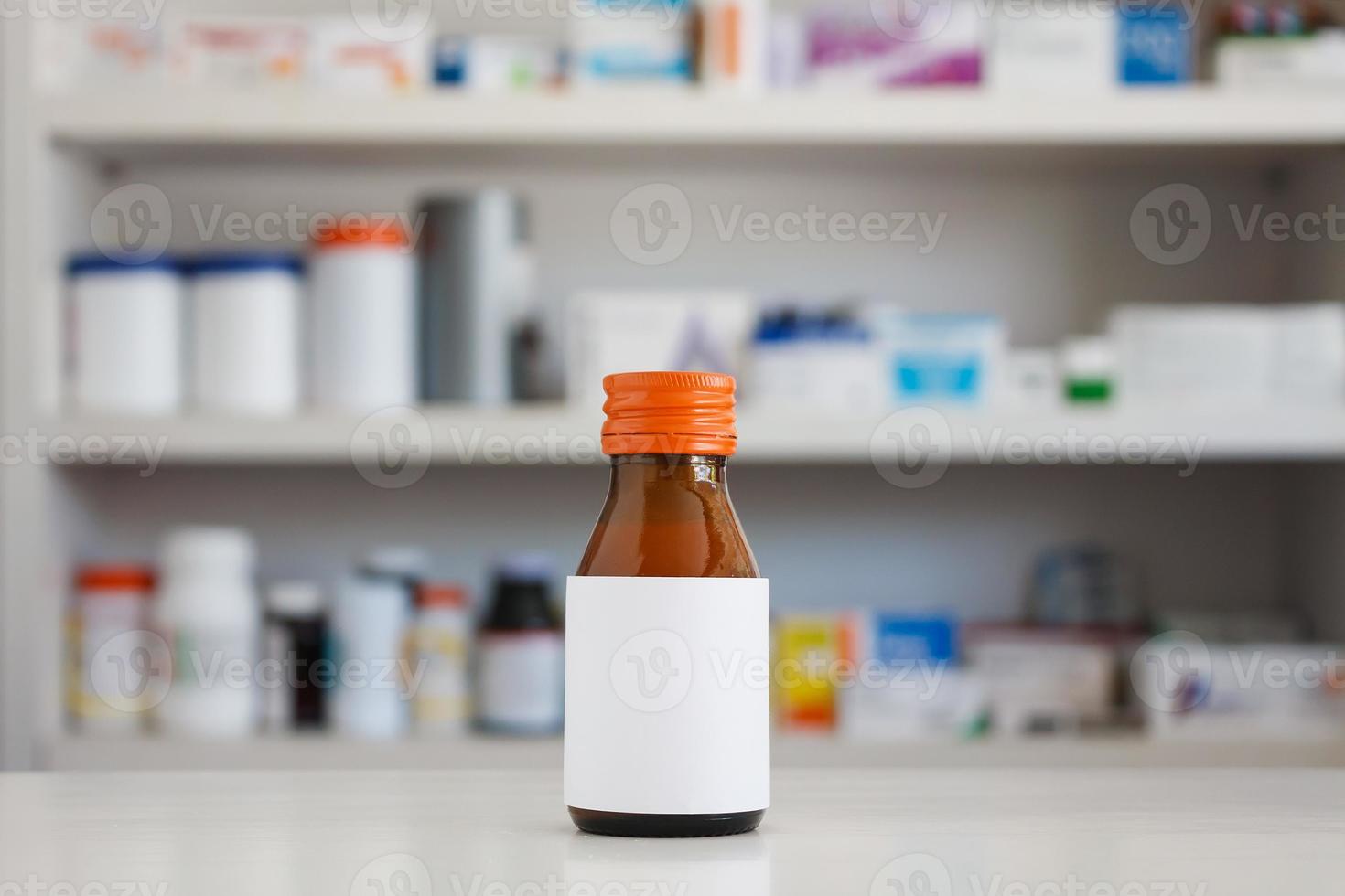 Blank white label of medicine bottle with blur shelves of drug in the pharmacy drugstore background photo