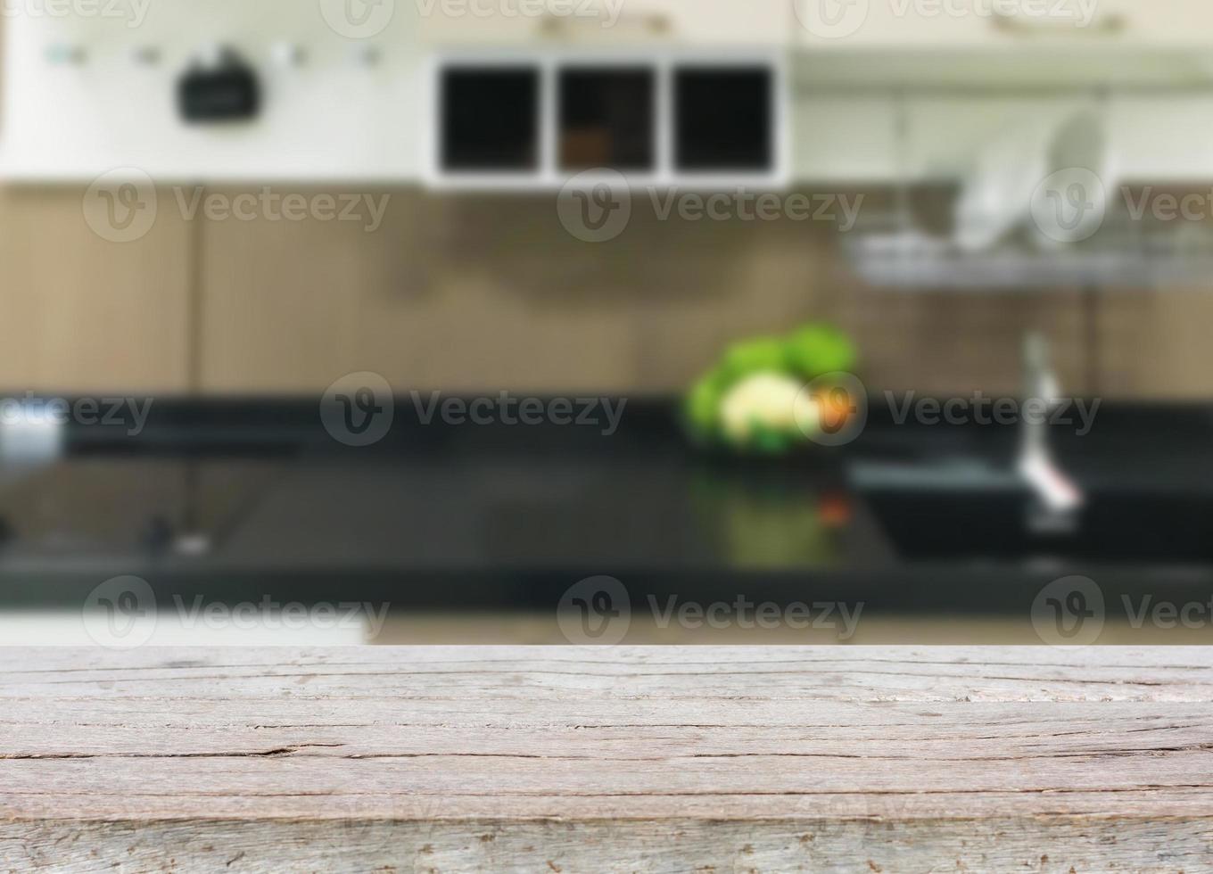 Empty wooden table and blurred kitchen background photo