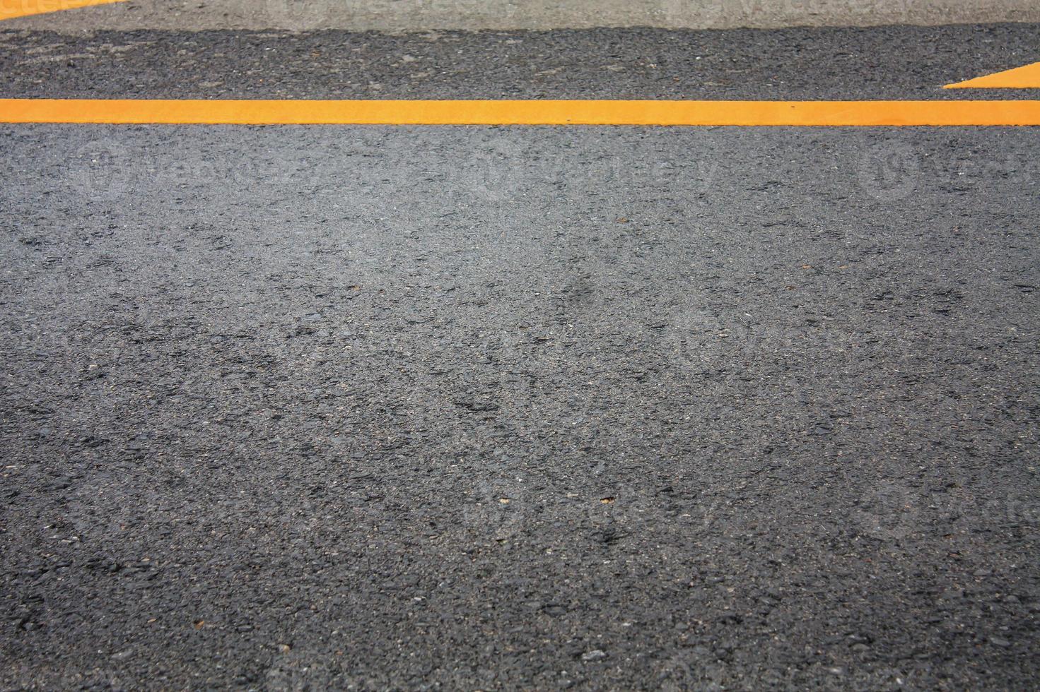 Asphalt road texture background with yellow dashed line photo