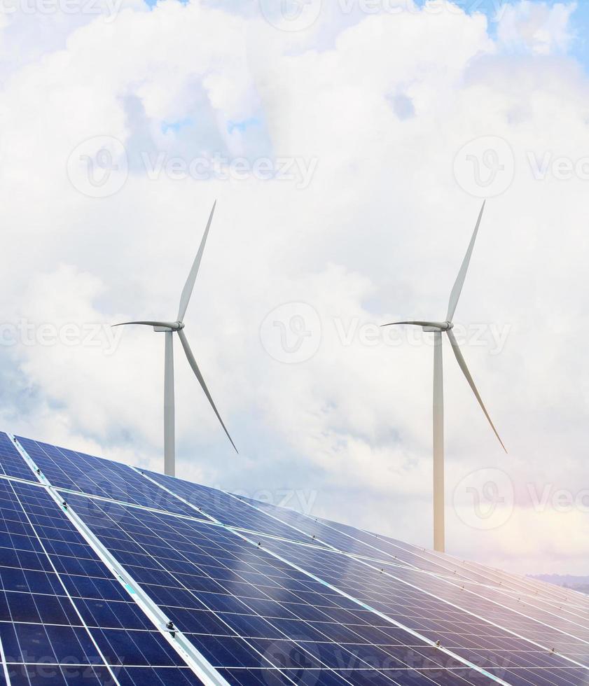 solar panels and wind turbines with the clouds and sky photo