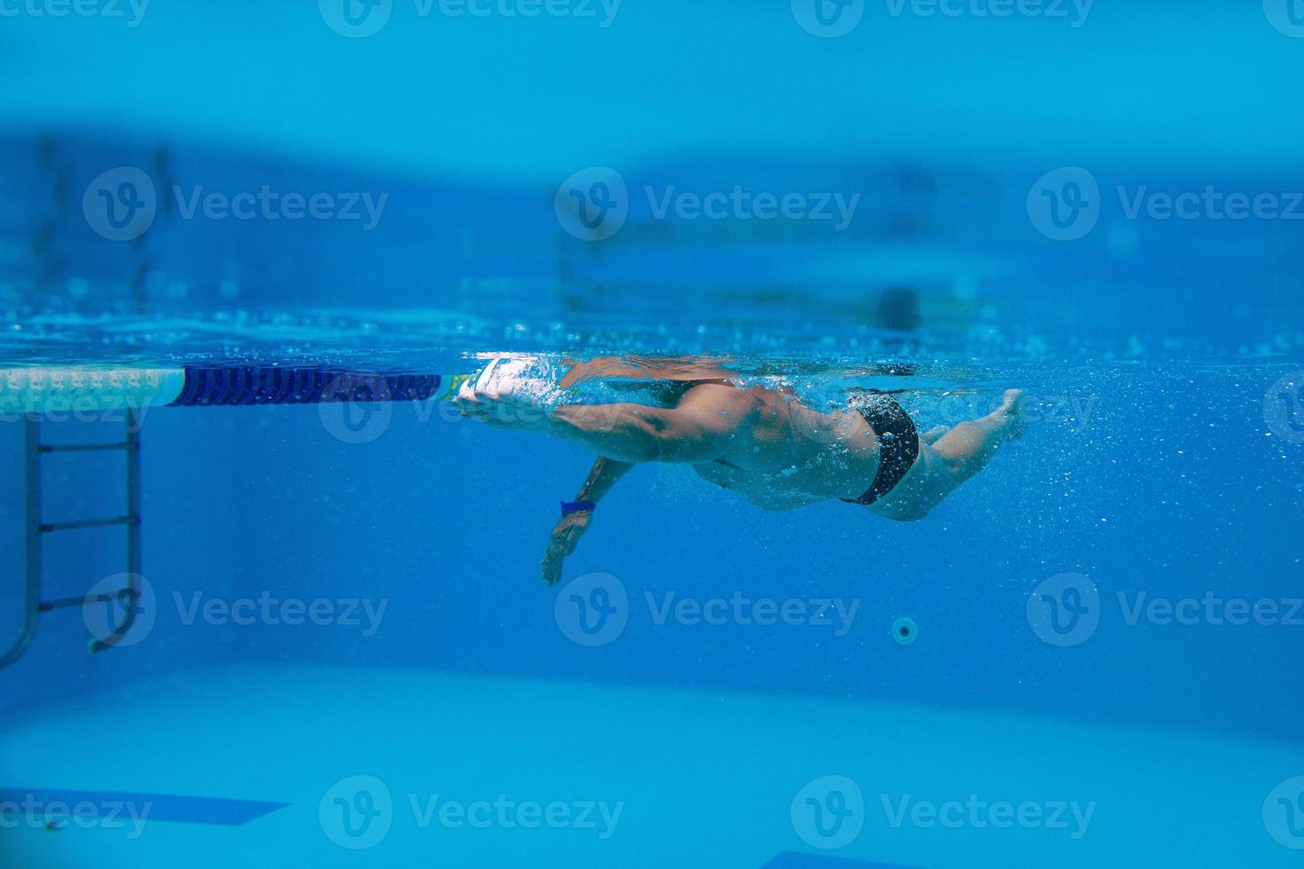 caucasian sportsman swimming in the swimming pool underwater photo