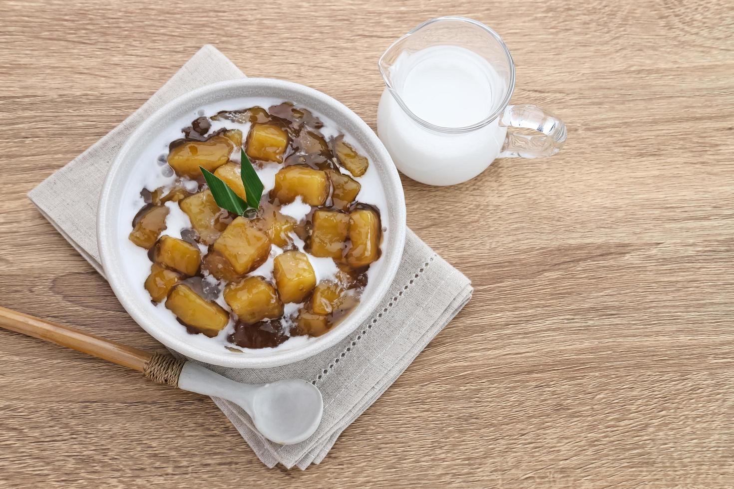 Bubur Ubi or Jenang Telo is a dessert from Indonesia made of sweet potato, palm sugar and tapioca flour served with coconut milk. photo