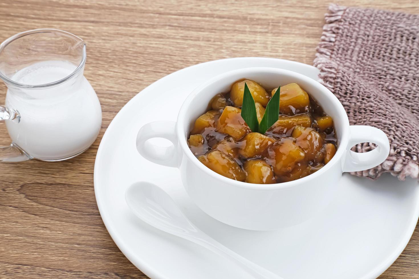Bubur Ubi or Jenang Telo is a dessert from Indonesia made of sweet potato, palm sugar and tapioca flour served with coconut milk. photo