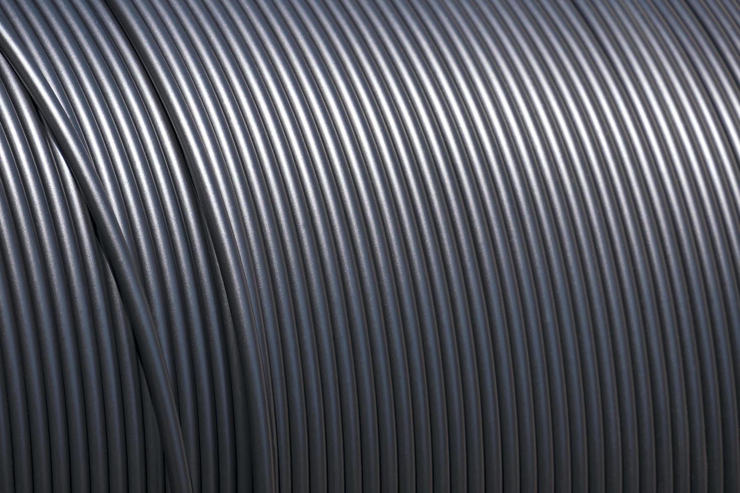 Close up roll of black fiber optic cable in single mode type on large wooden coil reel photo