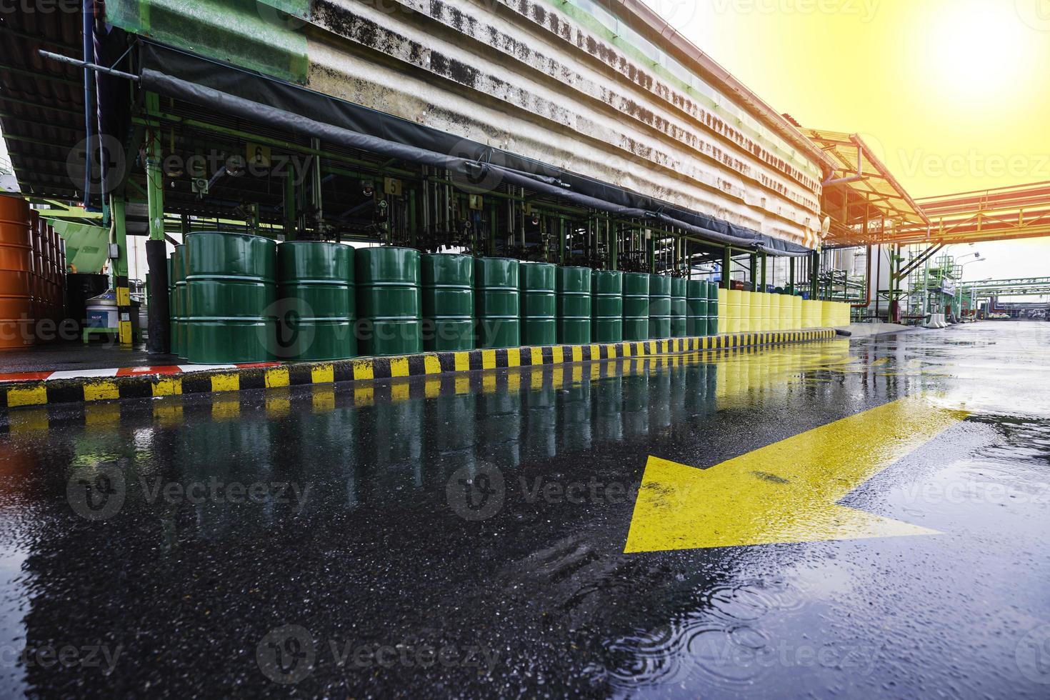 Oil barrels green or chemical drums vertical stacked up the industry road line symbol. photo