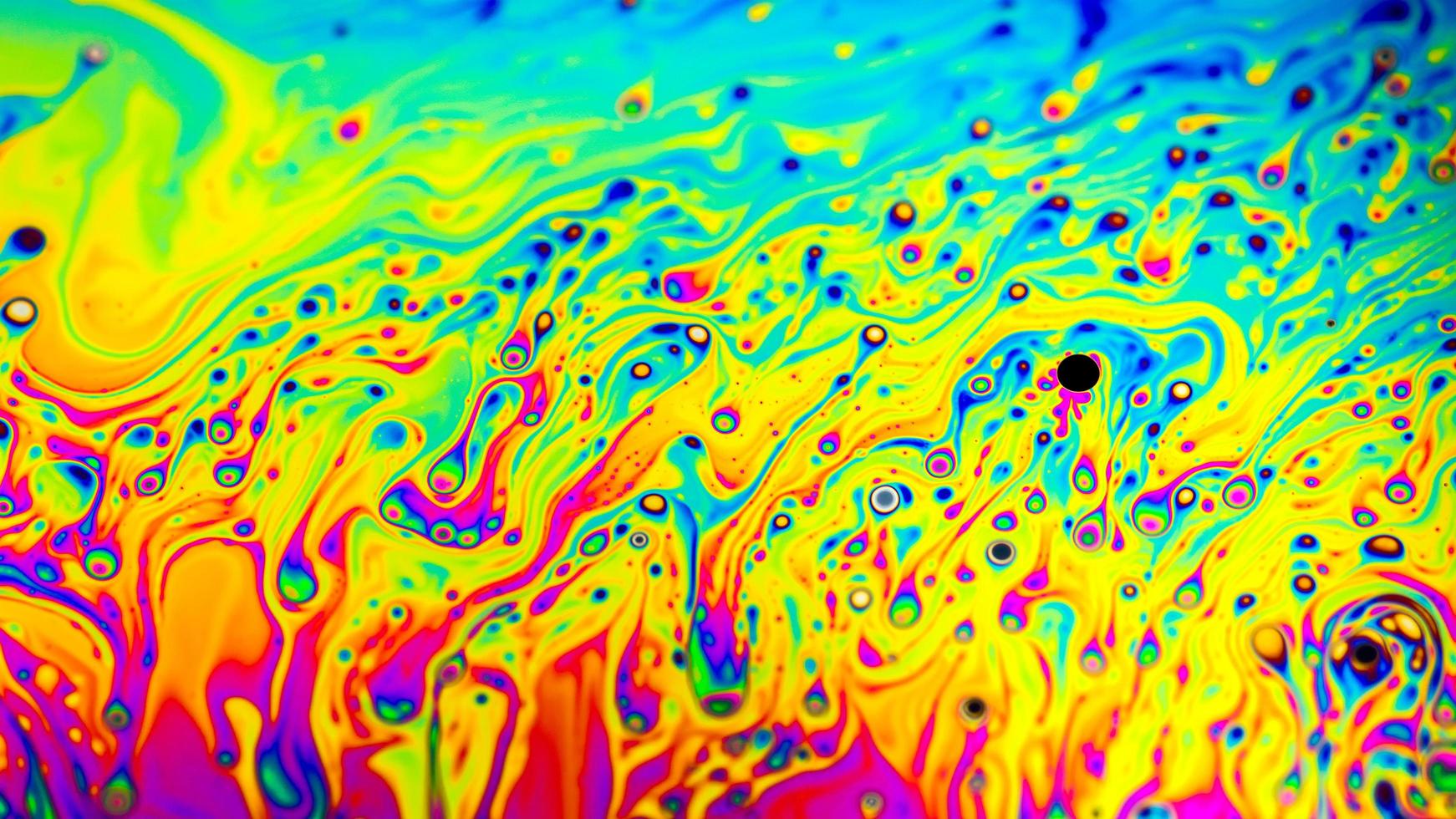 Extreme close-up of the colourful surface of a bubble photo