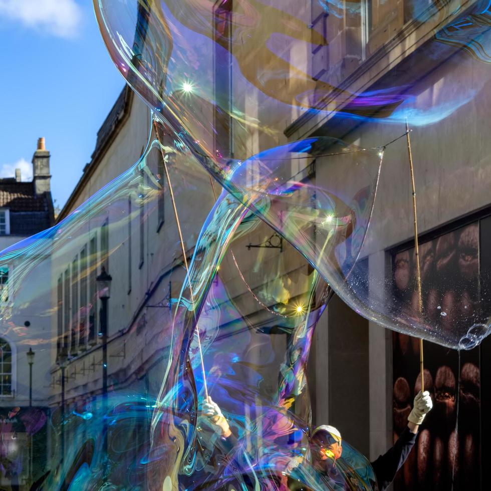 BATH, SOMERSET, UK, 2016. Bubblemaker working his magic in Bath on October 2, 2016. One unidentified man photo