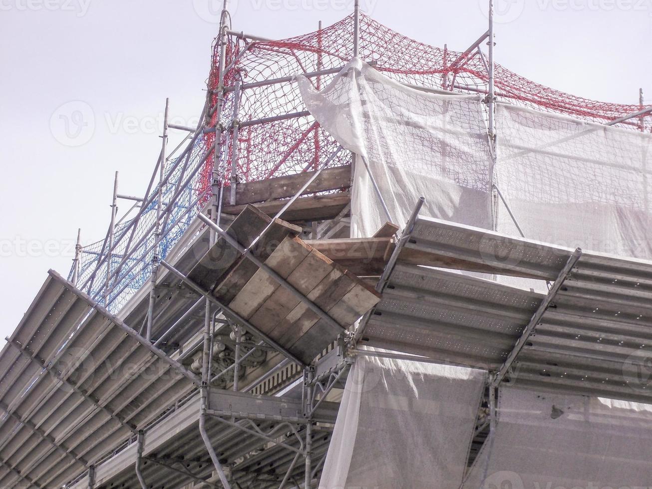 Temporary scaffold for construction works at building site photo