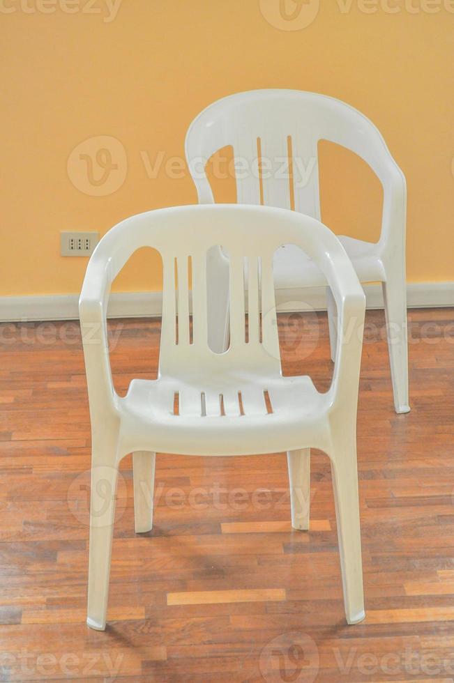 Two plastic chairs in a room photo