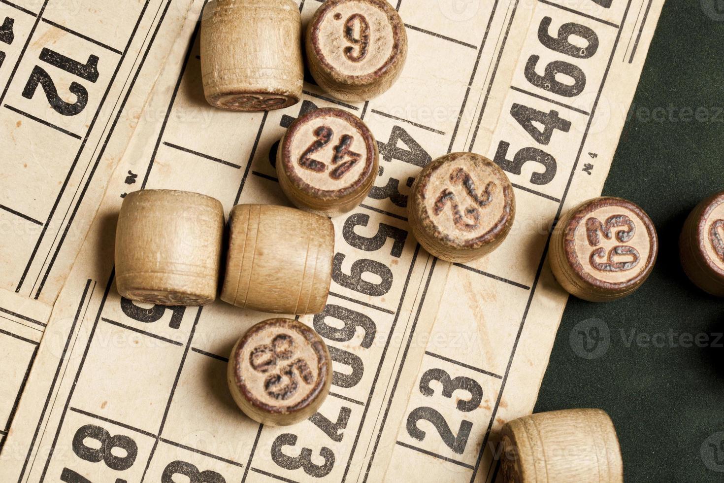 Table game Bingo. Wooden Lotto barrels with bag, playing cards for Lotto games, games for family. photo