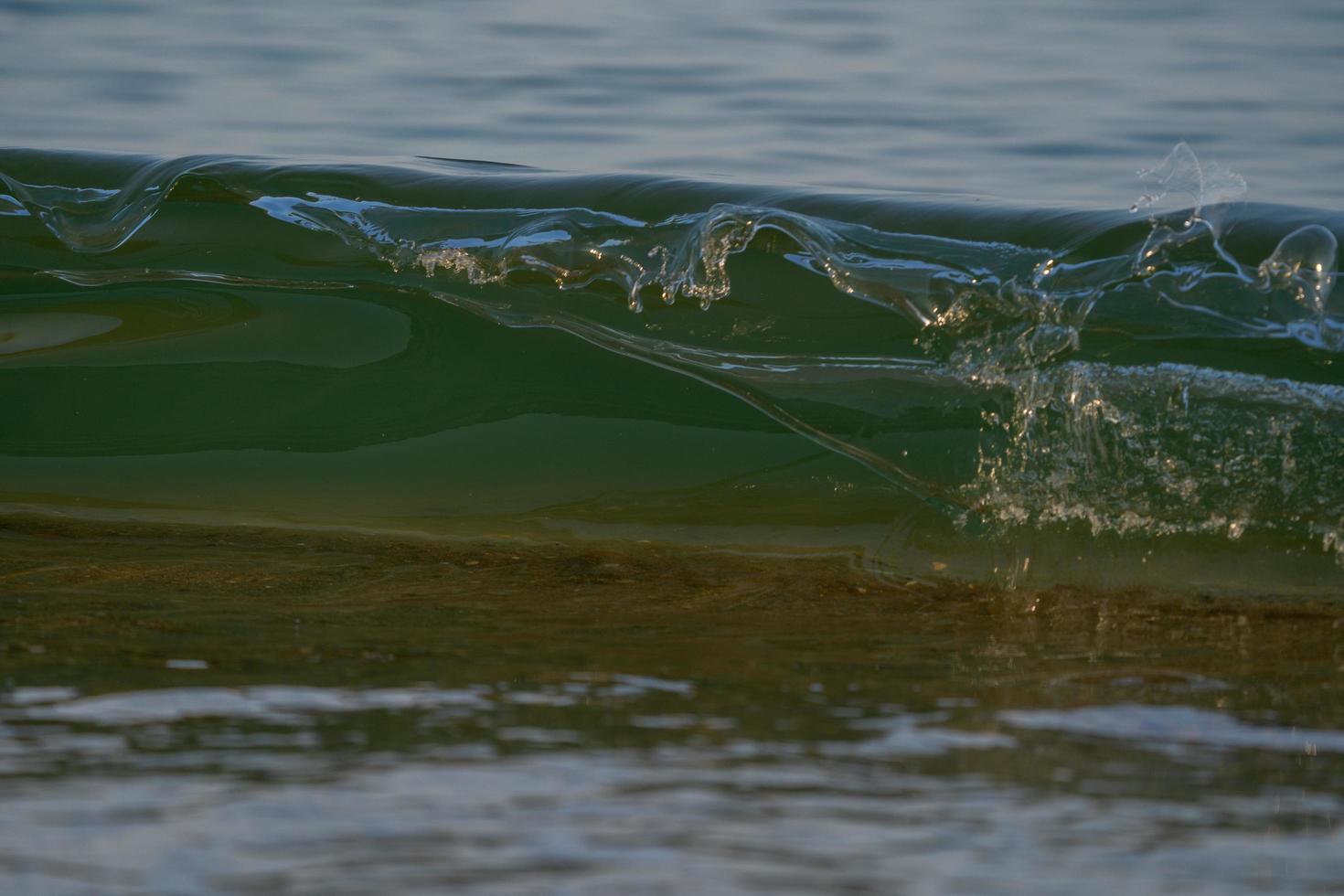 Waves about to break at low tide photo