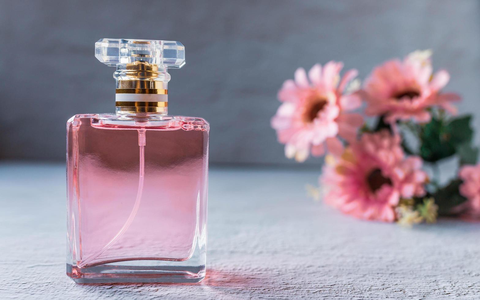 pink perfume bottle with pink flowers photo