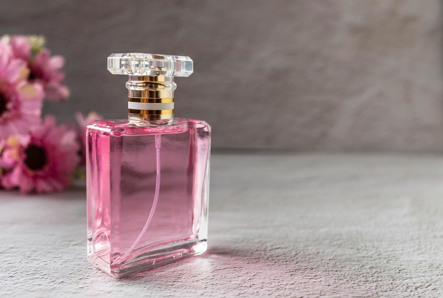 pink perfume bottle with pink flowers photo