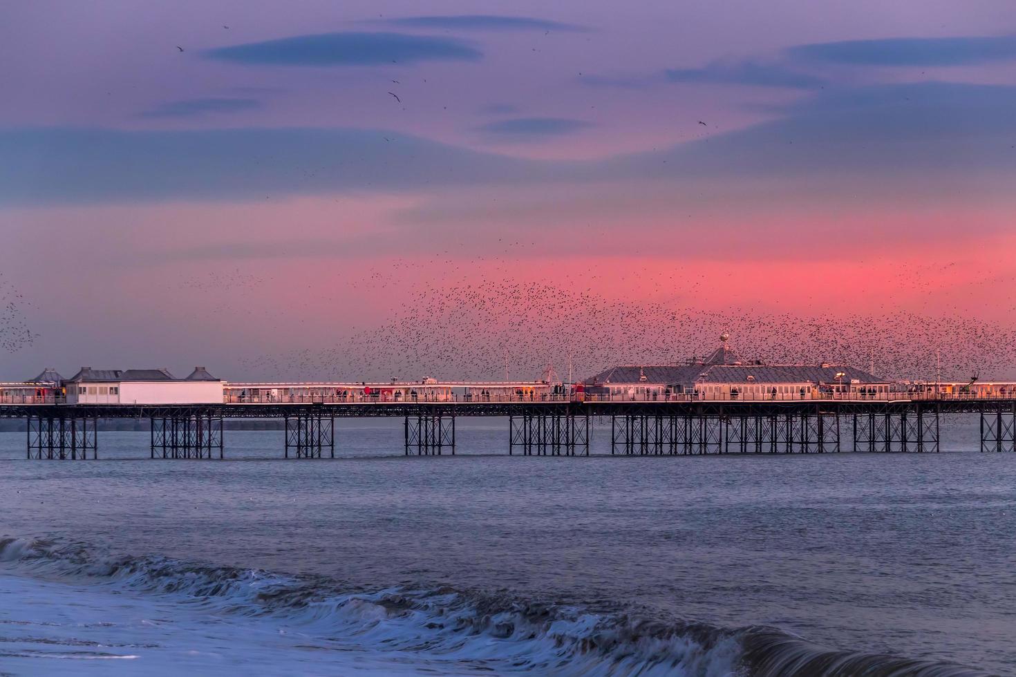 BRIGHTON, EAST SUSSEX, UK. Starlings over the Pier in Brighton East Sussex on January 26, 2018. Unidentified people photo