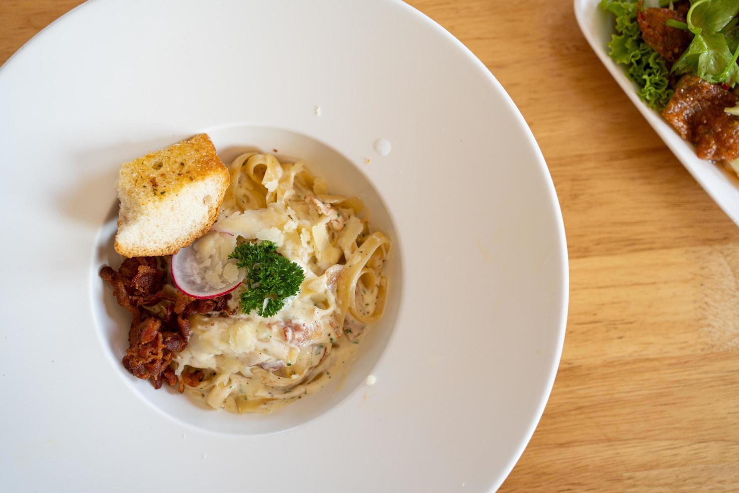 Pasta Spaghetti with black truffle, white mushroom, Cream Sauce and ricotta cheese. woonden background. Top view photo