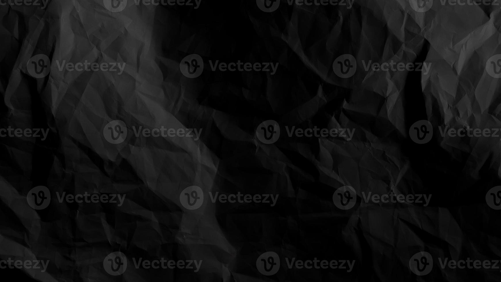 Black crumpled paper background with copy space for image or text photo