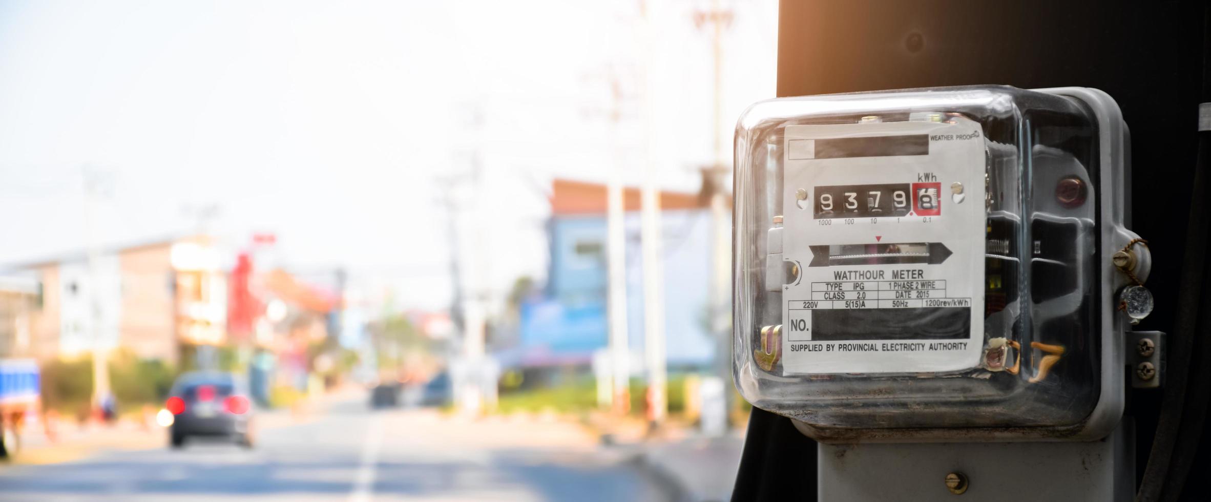 Watthour meter of electricity hung on the cement pole beside the road to monitor and measure power usage each houses in Asian countres. photo