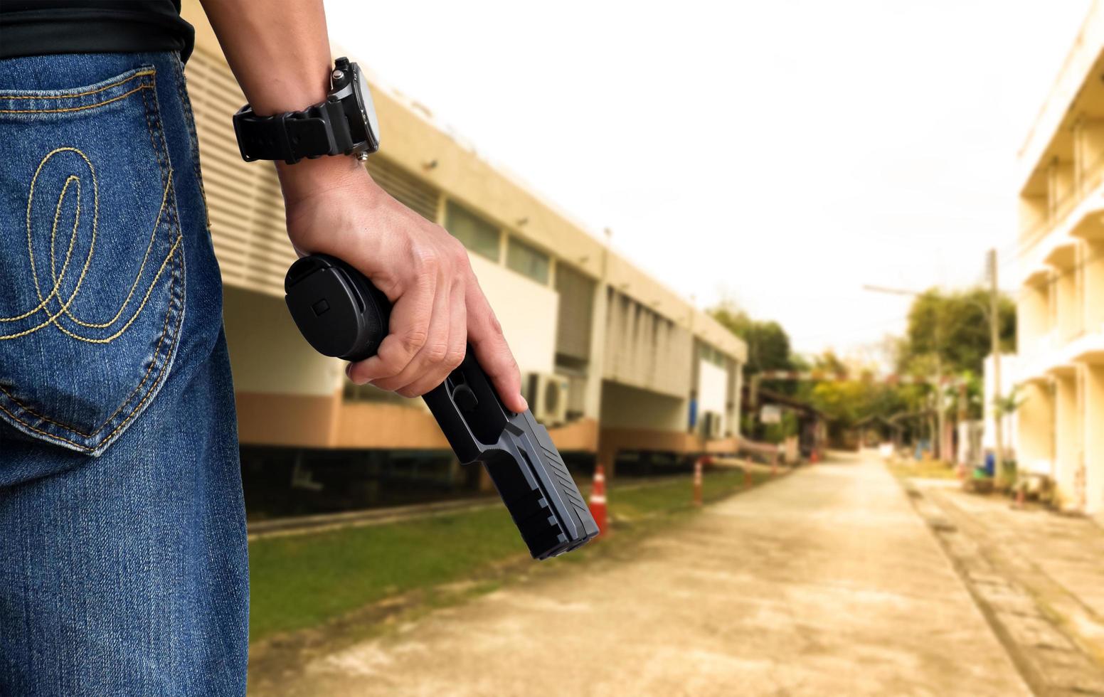 9mm automatic pistol holding in right hand of shooter, concept for security, robbery, gangster, bodyguard around the world. selective focus on pistol. photo