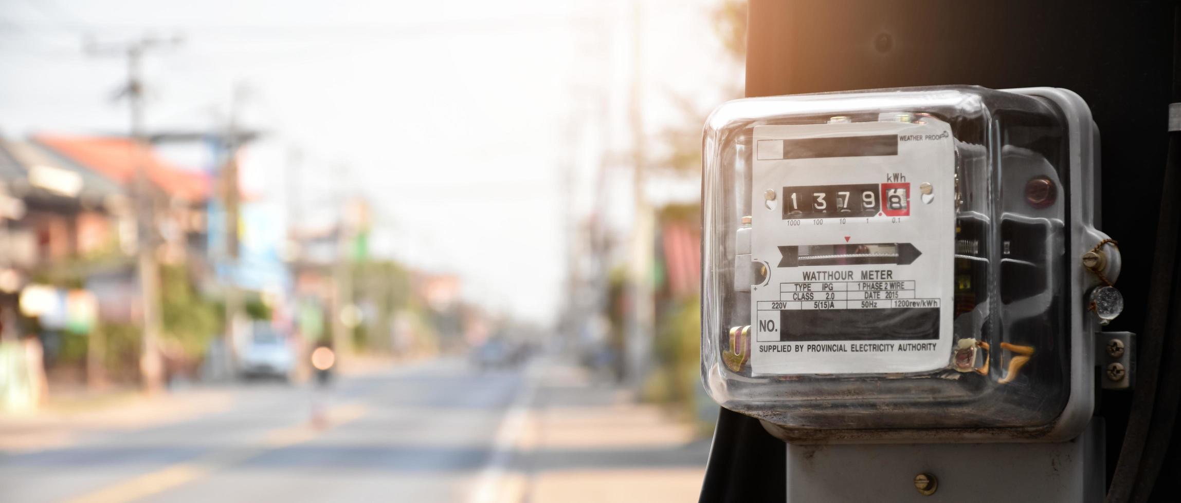 Watthour meter of electricity hung on the cement pole beside the road to monitor and measure power usage each houses in Asian countres. photo