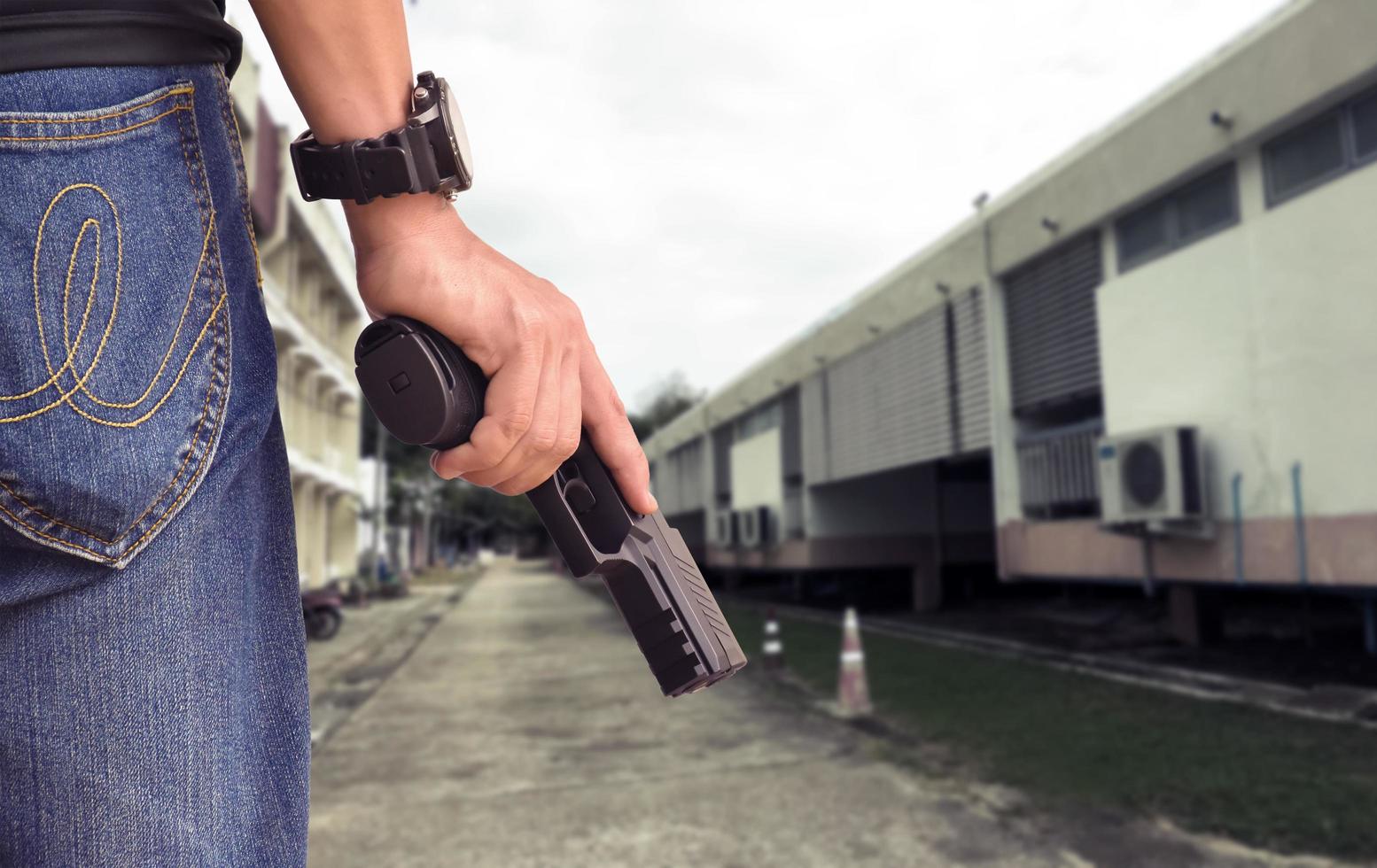 9mm automatic pistol holding in right hand of shooter, concept for security, robbery, gangster, bodyguard around the world. selective focus on pistol. photo