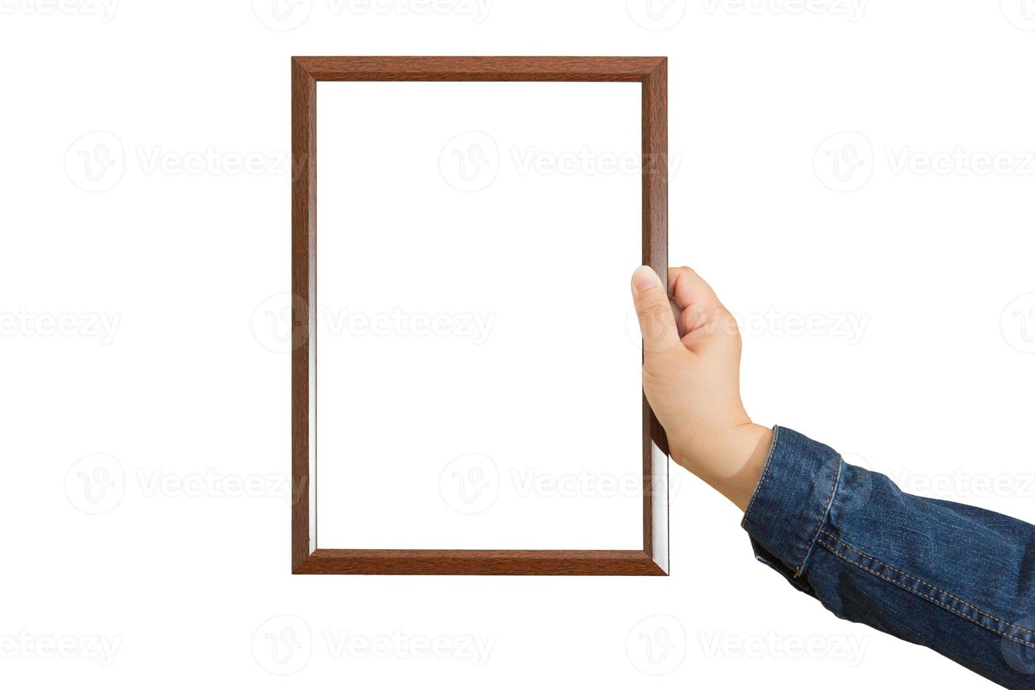 A blank diploma or a mockup certificate in the hand of a woman employee wearing a denim shirt on white background with a clipping path. The The vertical picture frame is empty and the copy space. photo