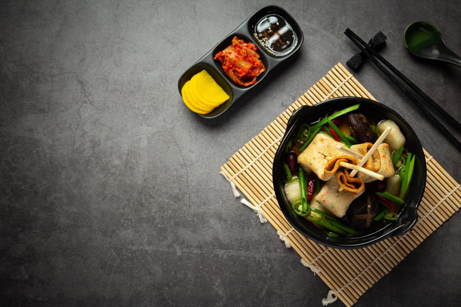 Korean fish cake and vegetable soup on table photo