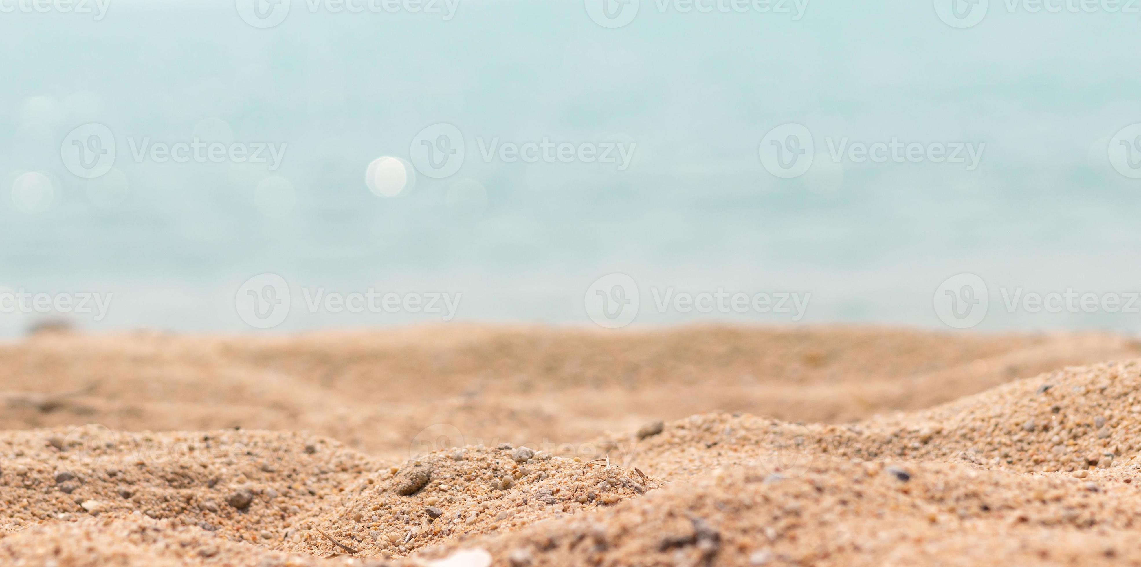 Close up surface of sand on the beach and blur foreground and blur
