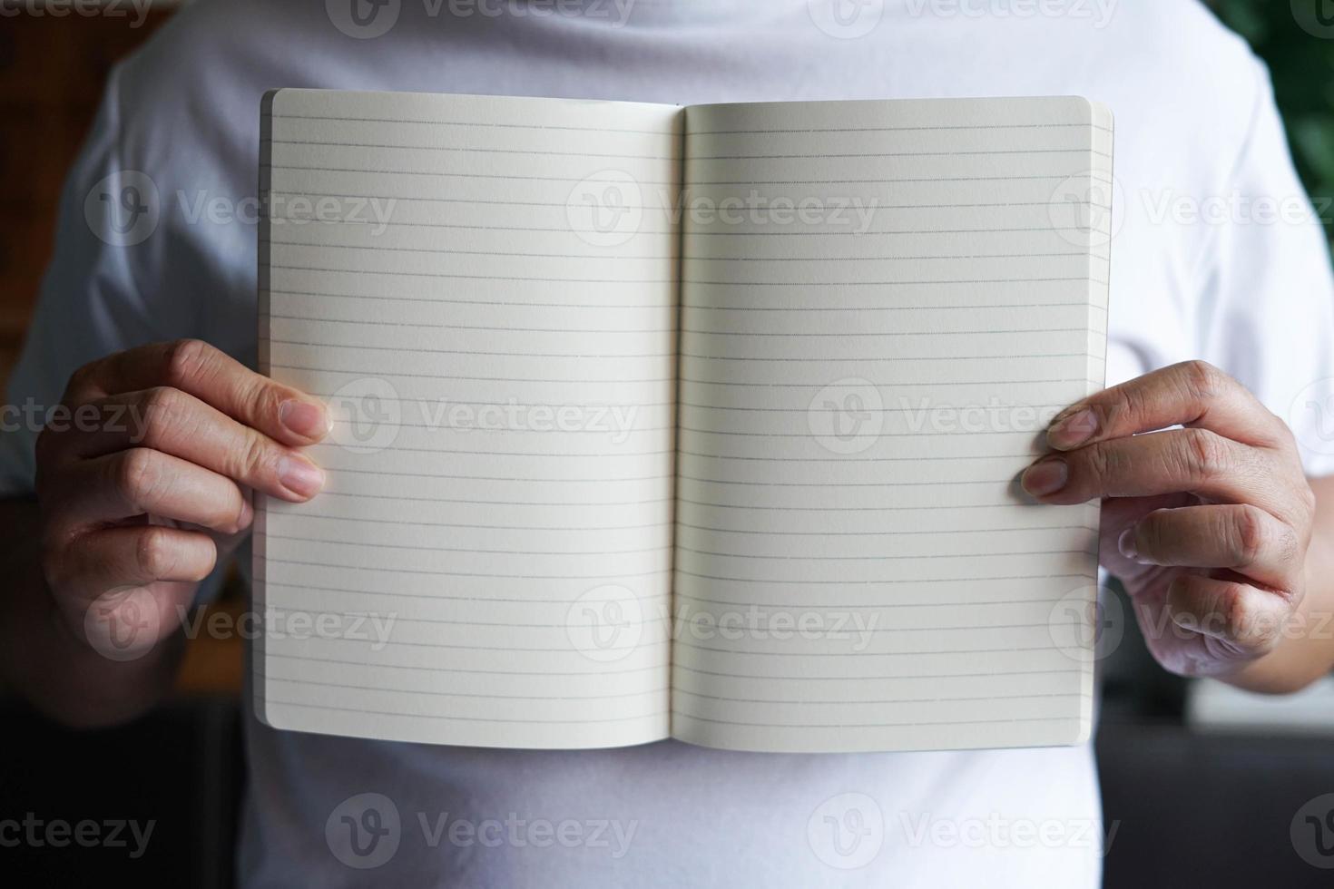 Man holding on a blank notebook with copy space. photo