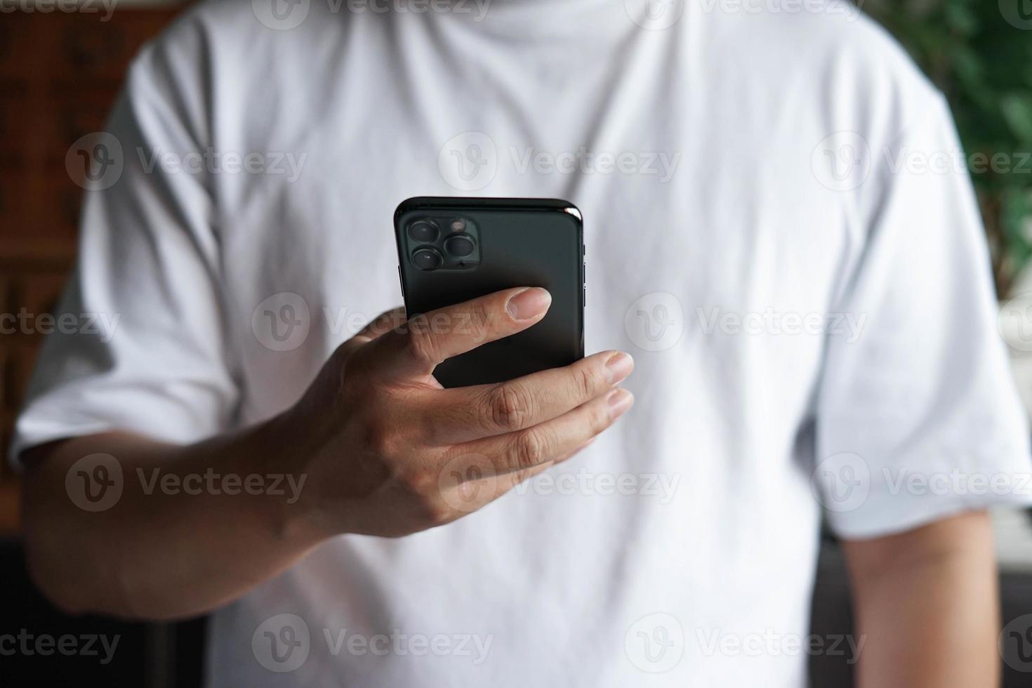 hombre usando y sosteniendo la mano en un teléfono móvil. foto