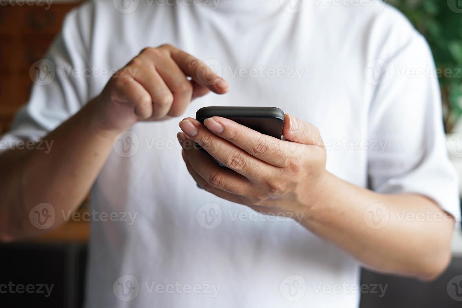 Man using mobile phone and point the finger to the phone. photo