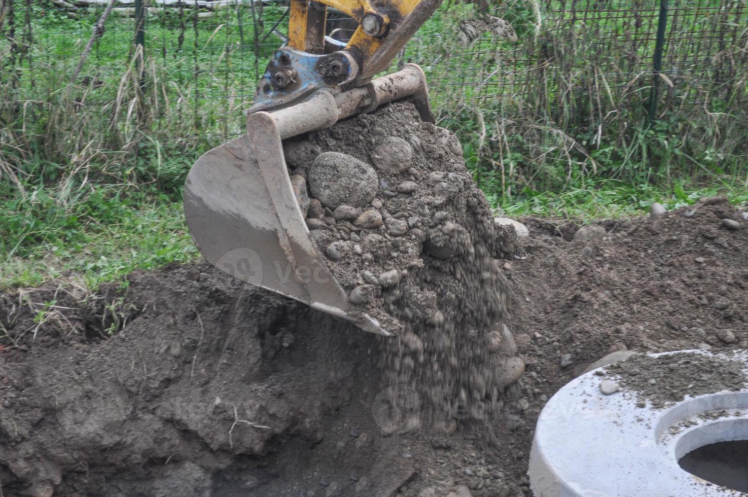 Excavator digging a hole photo