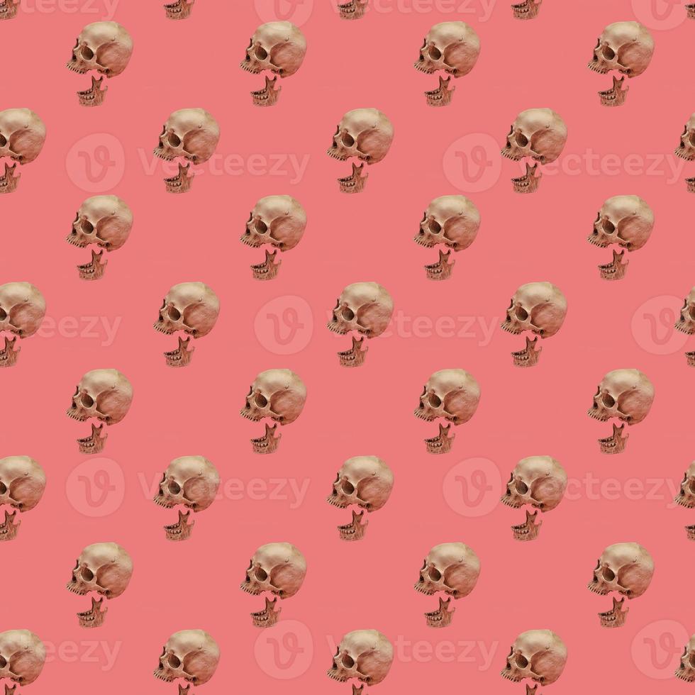 Skull with jaw on a pink seamless pattern. photo
