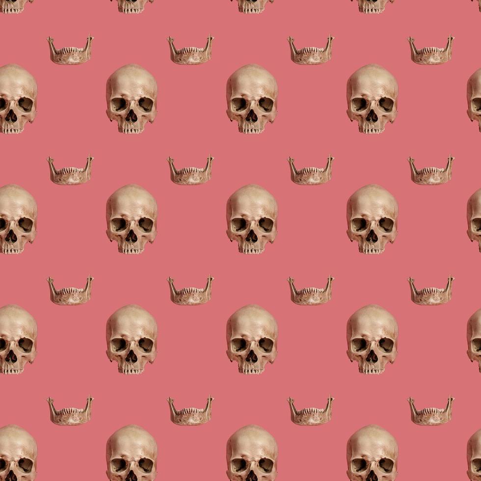 Skull with jaw on a pink seamless pattern. photo