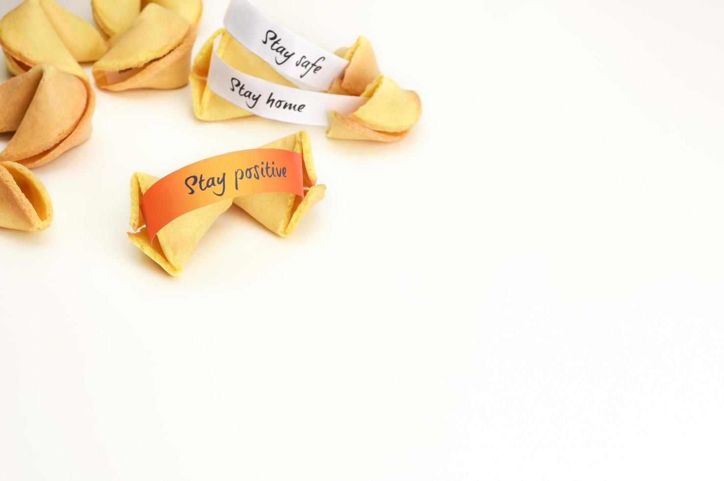 A fortune cookie with Stay Positive wish on orange paper. photo