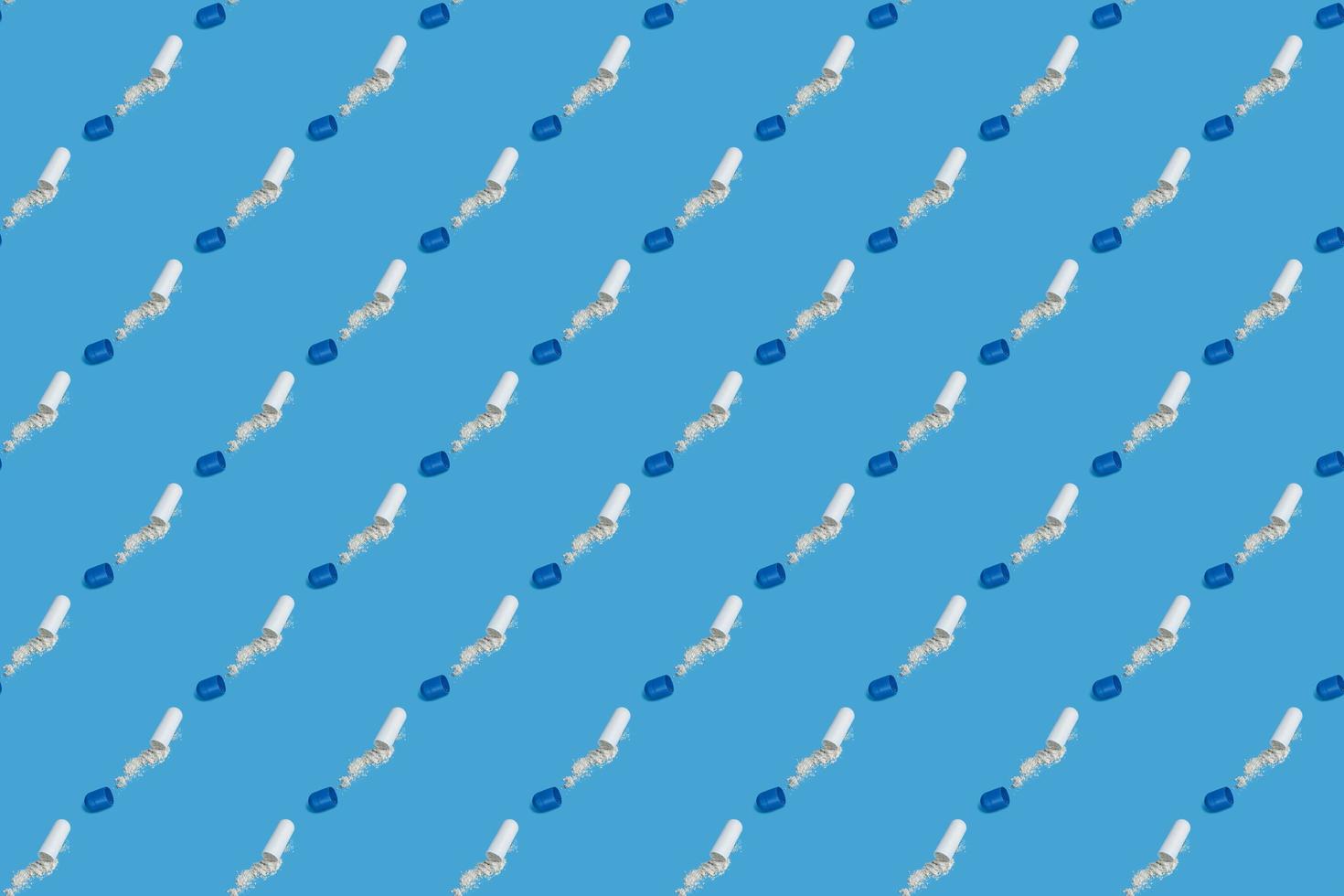 Open pilsl with powder off seamless pattern on blue background. photo