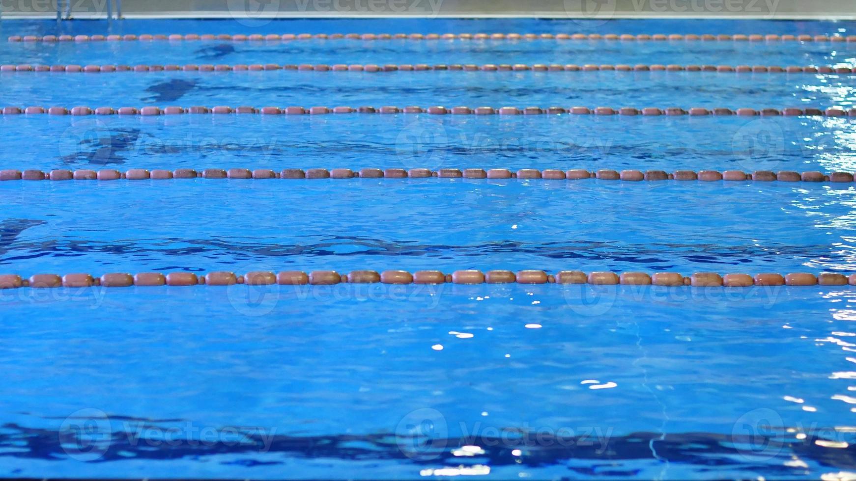 Swimming pool with blue water useful as background photo