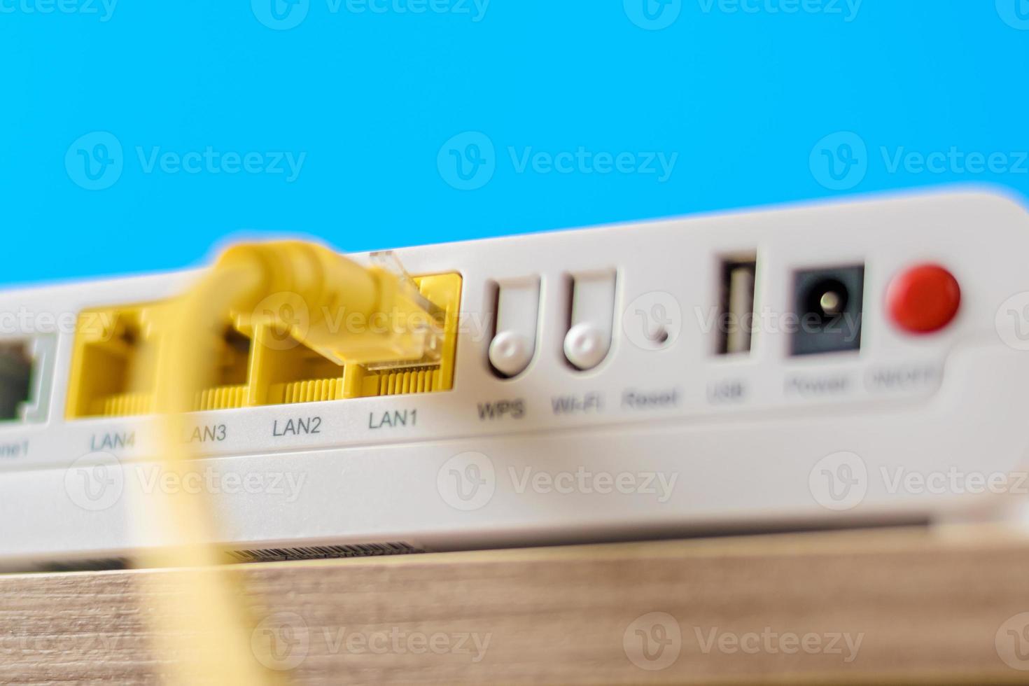 modern internet router with connecting cable, closeup photo