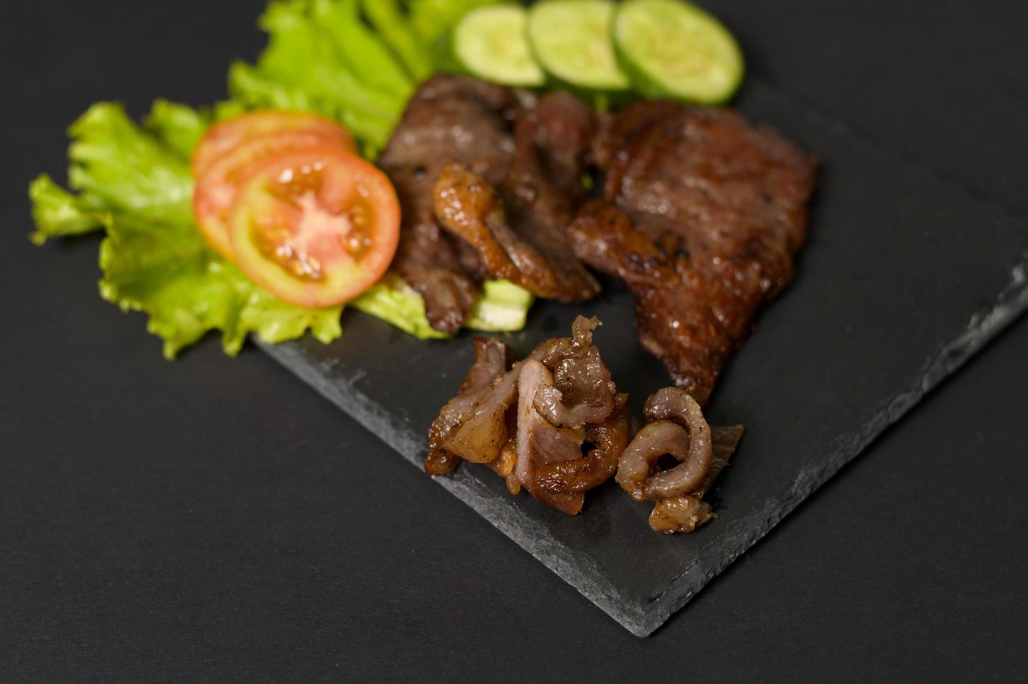 grilled beef on plate over black background studio photo